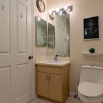 Hall bath with sink.  Medicine cabinet on the wall.

Looking East.