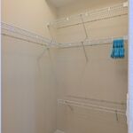 Primary bedroom walkin closet.  Shelving to hold your clothes.

Looking South.
