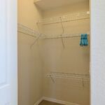 Primary bedroom walkin closet.  Shelving to hold your clothes.

Looking South.