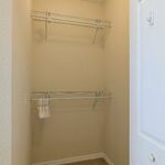 Primary bedroom walkin closet.  Shelving to hold your clothes.

Looking North.
