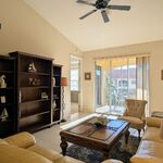 Living room sitting area with large coffee table and bookcase for all of your novels.

Looking West.
