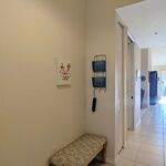 Foyer of unit.  Bench for seating and donning and doffing shoes.  Up north it would be jackets, but this is Florida!

Looking East.