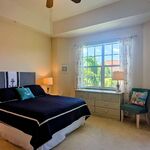 Primary bedroom with queen-sized bed and bedding.  Great pool views out the window.

Looking West.