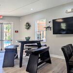 The clubhouse has many seating and entertaining areas.  The swimming pool is the the doors ahead.

Looking Southwest.