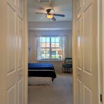 Looking from the private primary bathroom back out towards the bedroom.

Looking West.