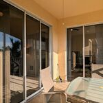 Multiple paths to and from the lanai.  Private slider to the right from the bedroom.  Multi panel slider on the left will completely open two-thirds of the way to provide great outdoor living indoors (amazing in the winter).

Looking South.